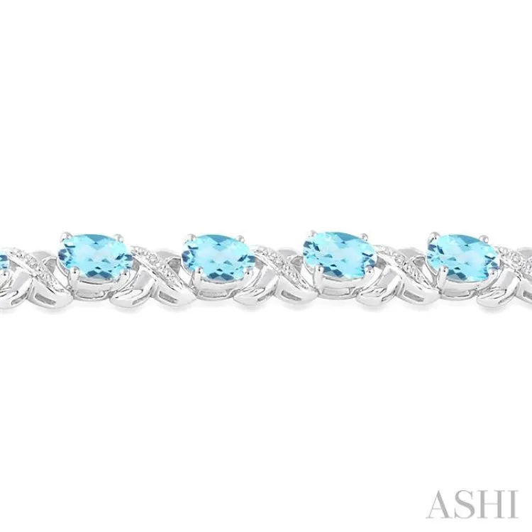 7x5 mm Oval Cut Blue Topaz and 1/20 Ctw Round Cut Diamond Fashion Bracelet in Sterling Silver