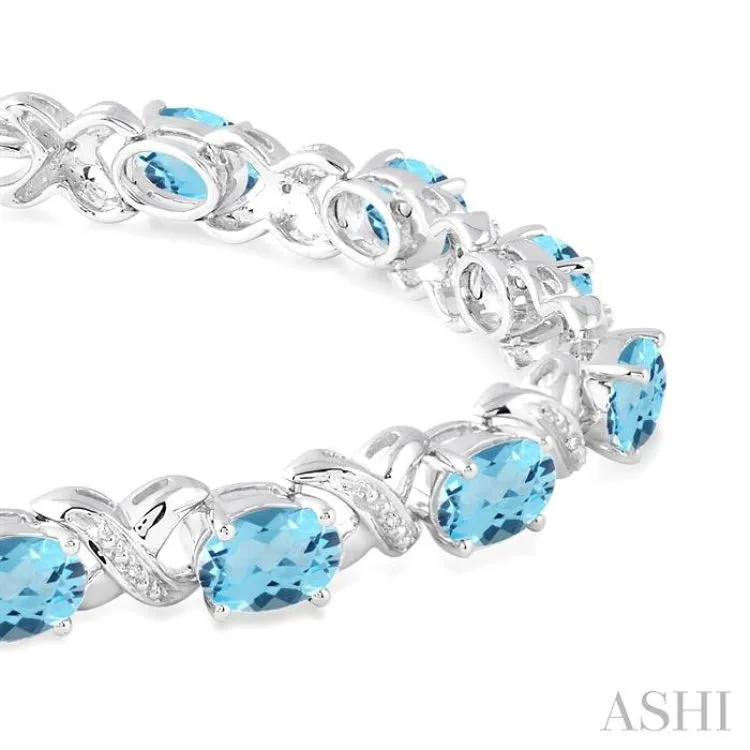 7x5 mm Oval Cut Blue Topaz and 1/20 Ctw Round Cut Diamond Fashion Bracelet in Sterling Silver